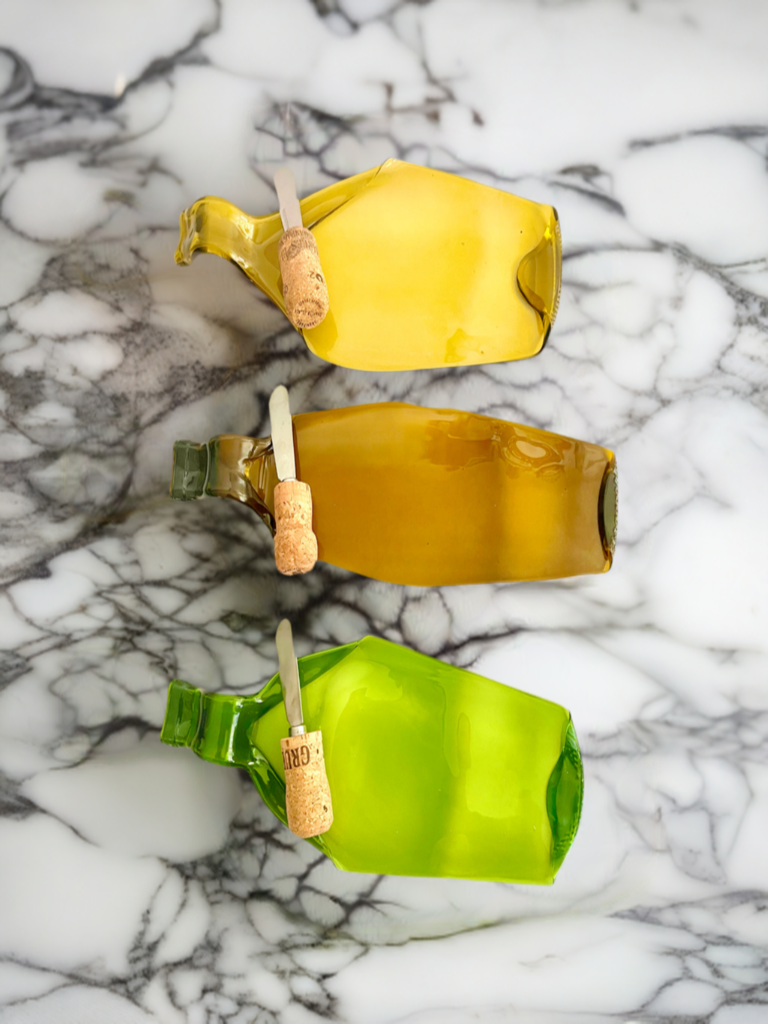 Handcrafted upcycled melted wine bottle cheese board with eco-friendly cork spreader – perfect for charcuterie, appetizers, and gifts.