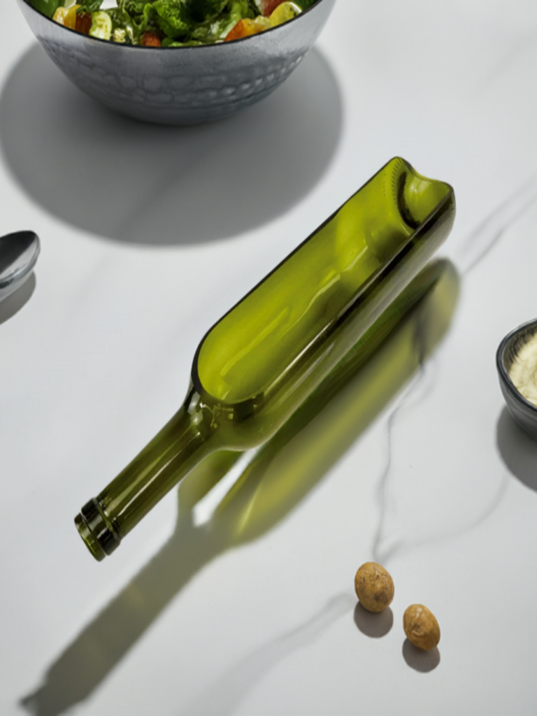 A horizontally side cut wine bottle crafted as a planter, in green color, with no visible plants.