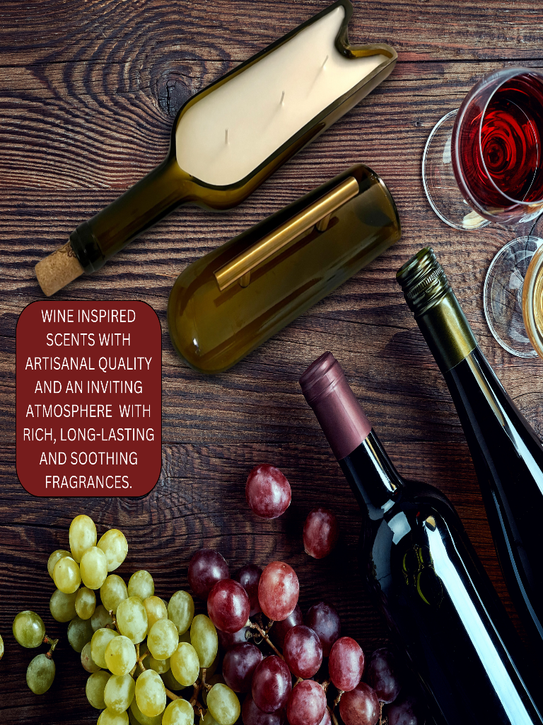 Brown glass bottle repurposed as a candle holder with three lit candles inside next to wine bottles, grapes, and red wine.