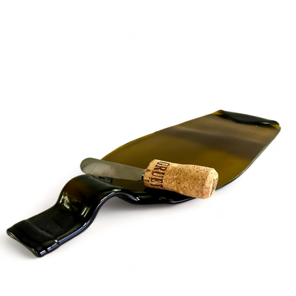 Handcrafted melted wine bottle cheese board with cork spreader – sustainable charcuterie tray.